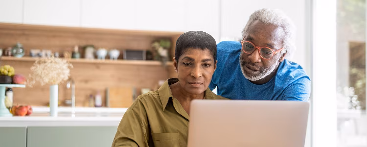 Educator working with an older adult learner at a desk